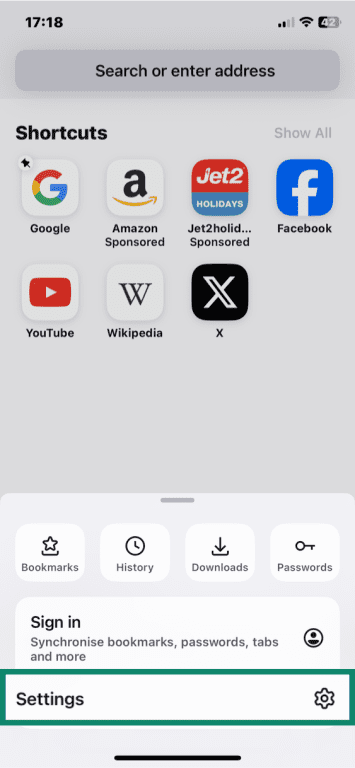 Firefox on iOS with Settings option highlighted in pop-up menu