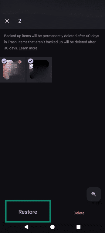 The Google Photos trash menu, highlighting the Restore option underneath 2 selected photographs.