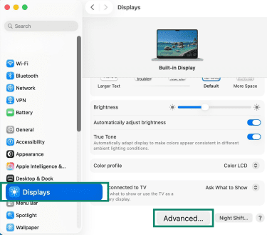 macOS System Settings showing the Displays menu with the "Advanced" button highlighted.